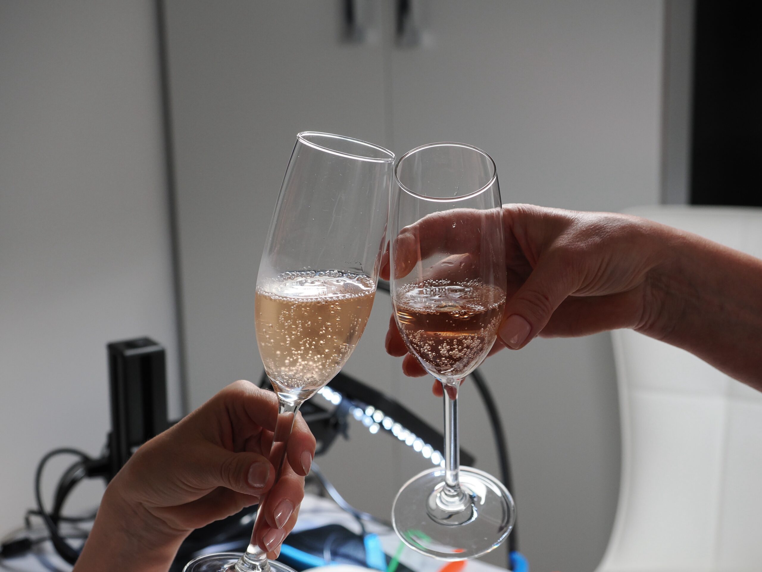 Toasting with a glass of bubbly while a PearlStone.Art permanent piece is fitted
